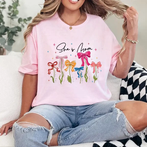 She Is Mom T-Shirt – Retro Coquette Bow Christian Mom Shirt, Bible Verse 'She Is Strong' Tee, Cute Mother's Day Gift for Faithful Mama