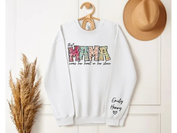 Custom-Mama-Sweatshirt-with-Kid-Name-This-Mama-Wear-Her-Heart-On-Her-Sleeve-Sweatshirt-Personalized-Mom-Shirt-With-Names-Mothers-Day-Gift-4.jpg Custom Mama Shirt, Heart on Sleeve, Personalized Gift for Mom