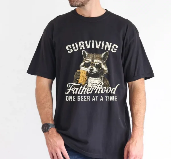 Surviving-Fatherhood-One-Beer-At-A-Time-1.webp Surviving Fatherhood One Beer At A Time, Funny Father Tee, Drinking Husband, Fathers Day Gift, Gift for Dad, Sarcastic Dad Grandpa T-Shirt