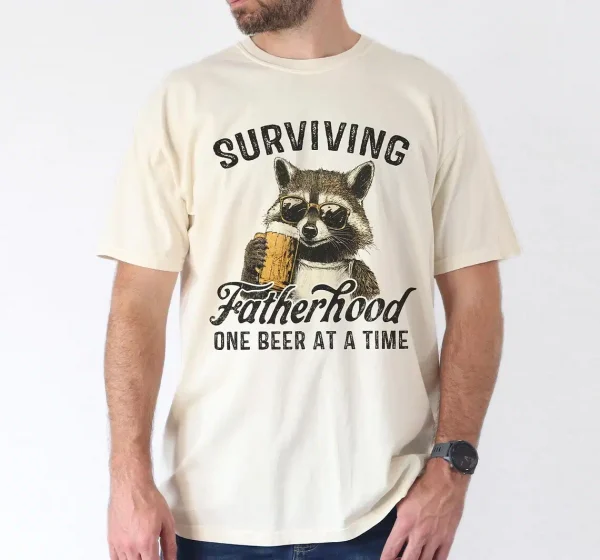 Surviving-Fatherhood-One-Beer-At-A-Time-3.webp Surviving Fatherhood One Beer At A Time, Funny Father Tee, Drinking Husband, Fathers Day Gift, Gift for Dad, Sarcastic Dad Grandpa T-Shirt