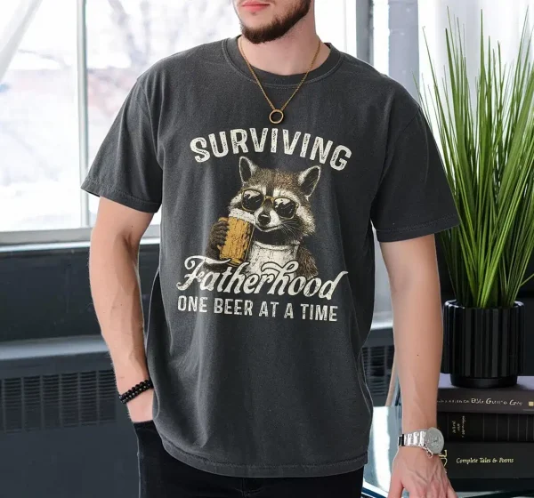 Surviving-Fatherhood-One-Beer-At-A-Time-4.webp Surviving Fatherhood One Beer At A Time, Funny Father Tee, Drinking Husband, Fathers Day Gift, Gift for Dad, Sarcastic Dad Grandpa T-Shirt